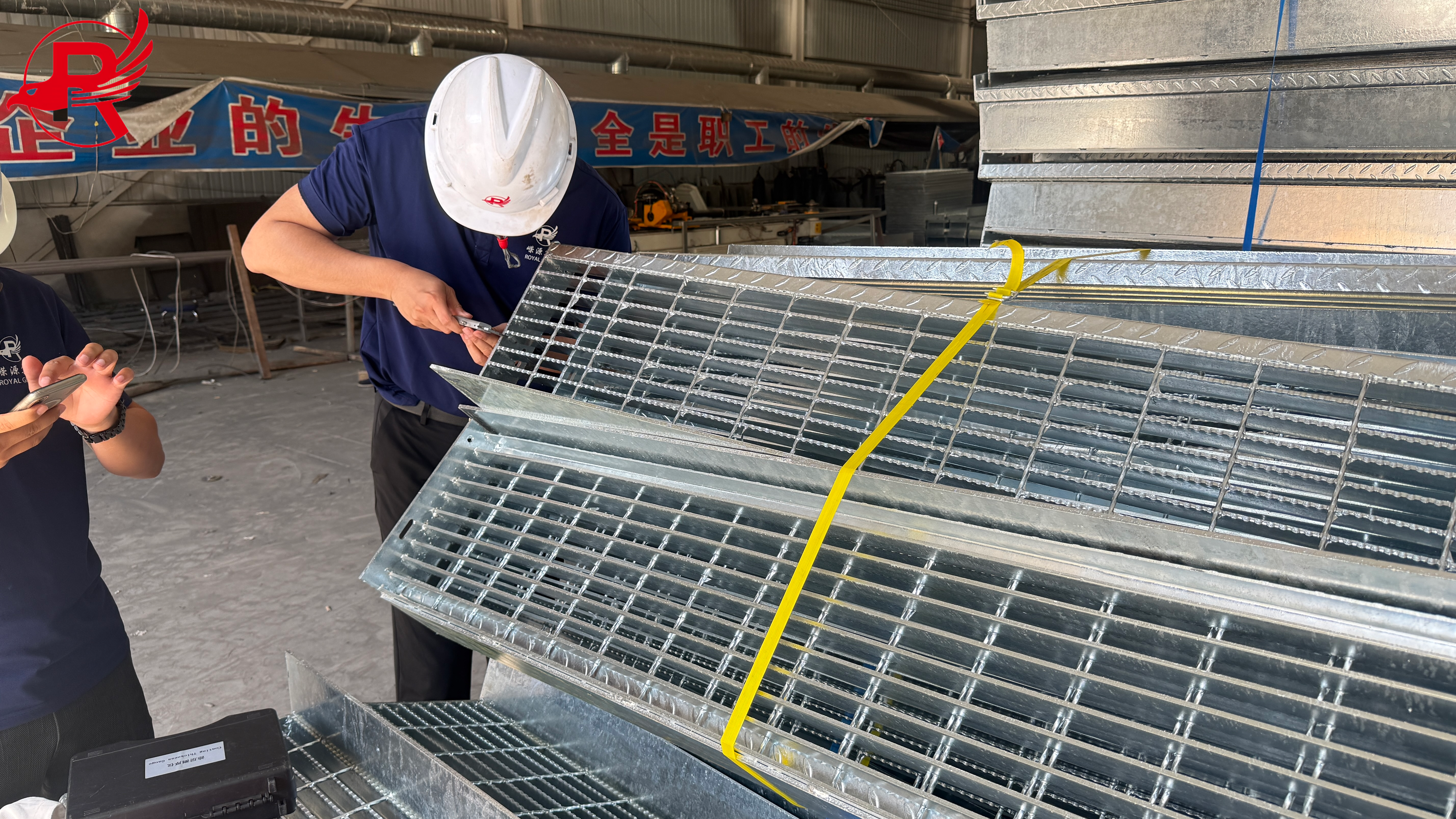 Inspectors are testing hot-dip galvanized steel grating.